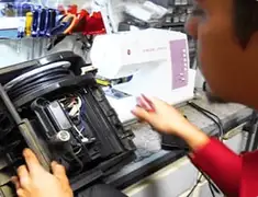 Vacuum repair technician servicing internal components on a workbench in Charlotte, NC